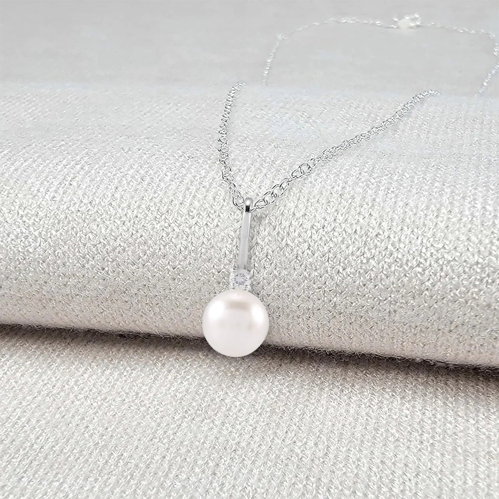 Pearl necklace on a textured surface - Pearl Anniversary Gift