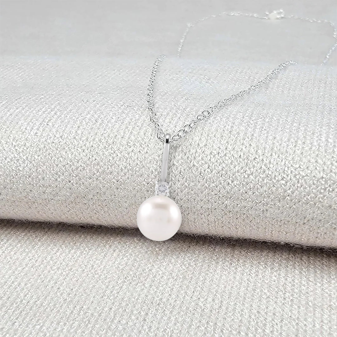 Pearl necklace on a textured surface - Pearl Anniversary Gift