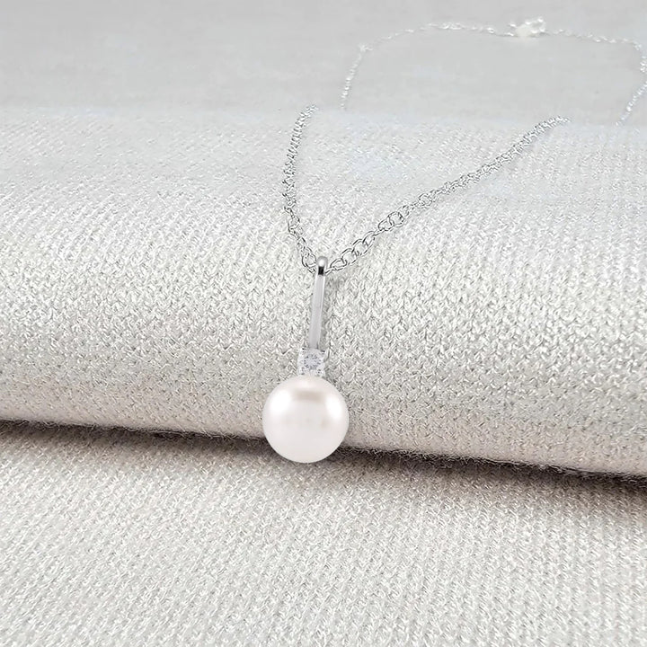 Pearl necklace on a textured surface - Pearl Anniversary Gift