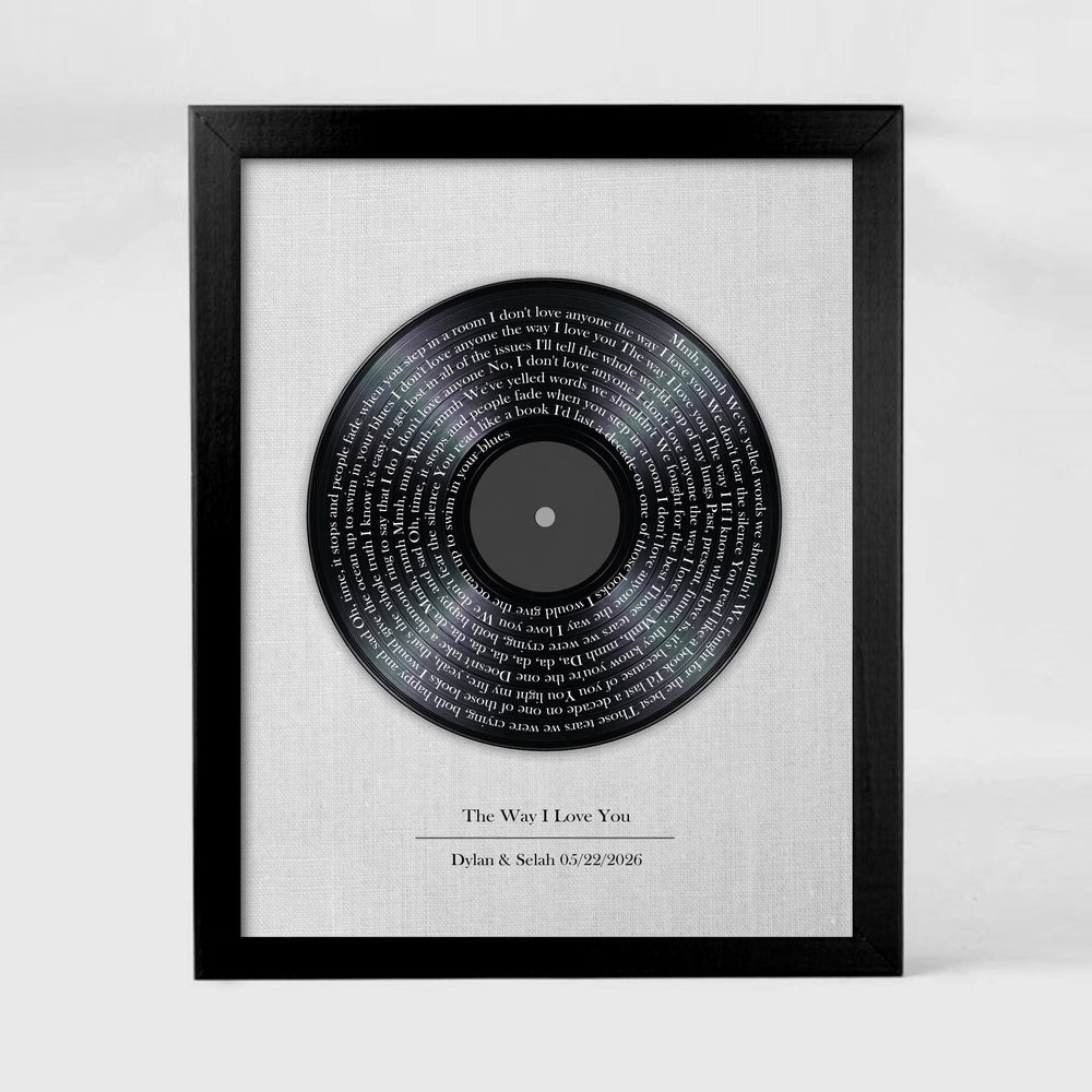 Framed vinyl record with engraved text on a white background
