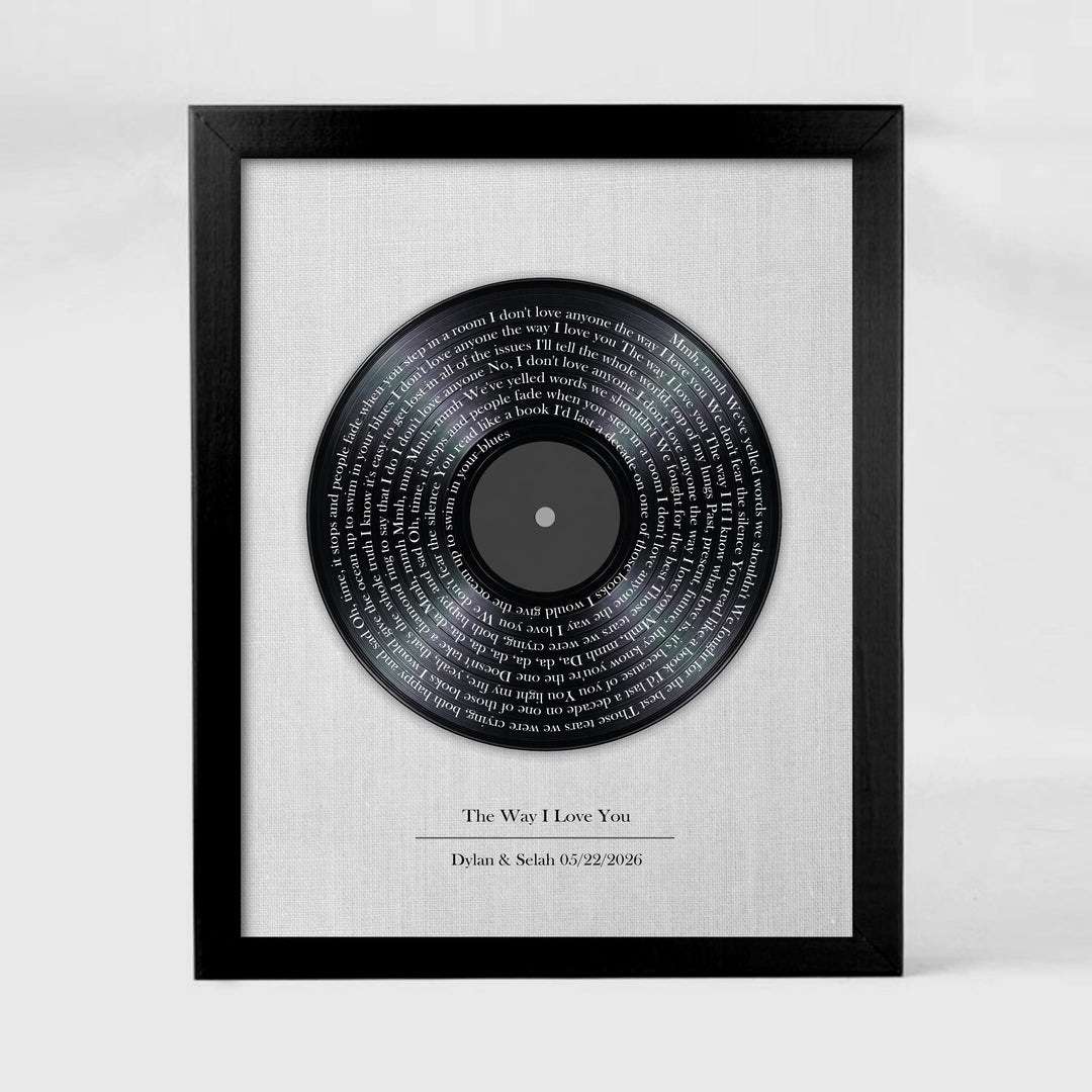 Framed vinyl record with engraved text on a white background
