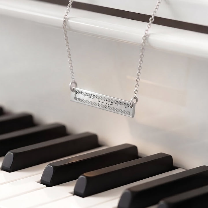 Necklace with musical sheet music pendant 