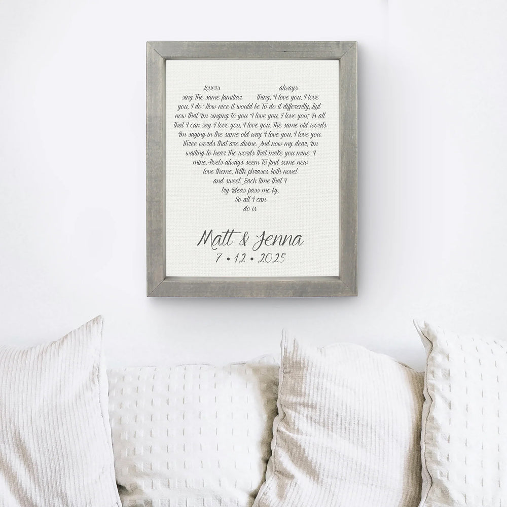 Custom Linen anniversary framed print with text on a wall above a sofa