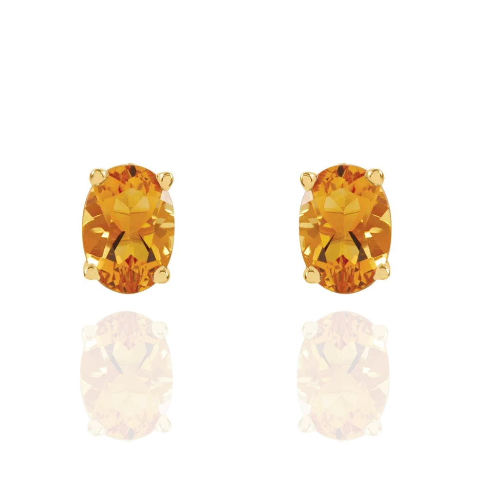 Pair of citrine gemstone earrings on a white background