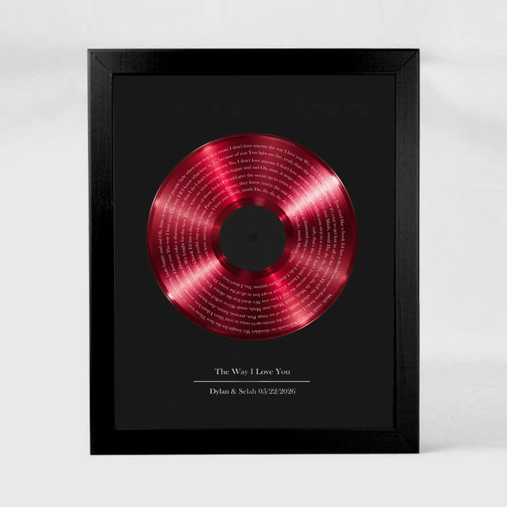 Framed red vinyl record with text on a black background