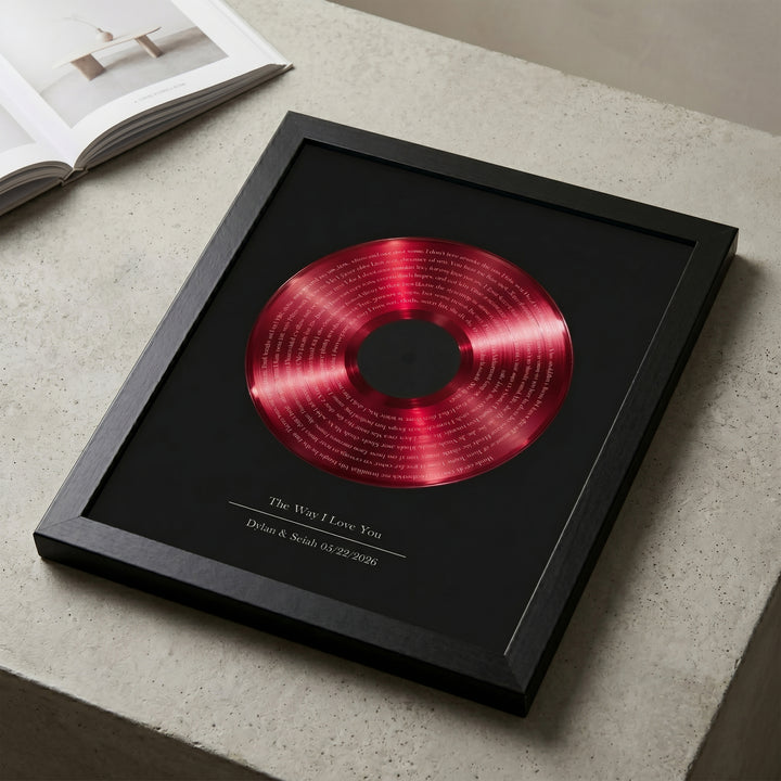 Framed red vinyl with lyrics print on a black surface
