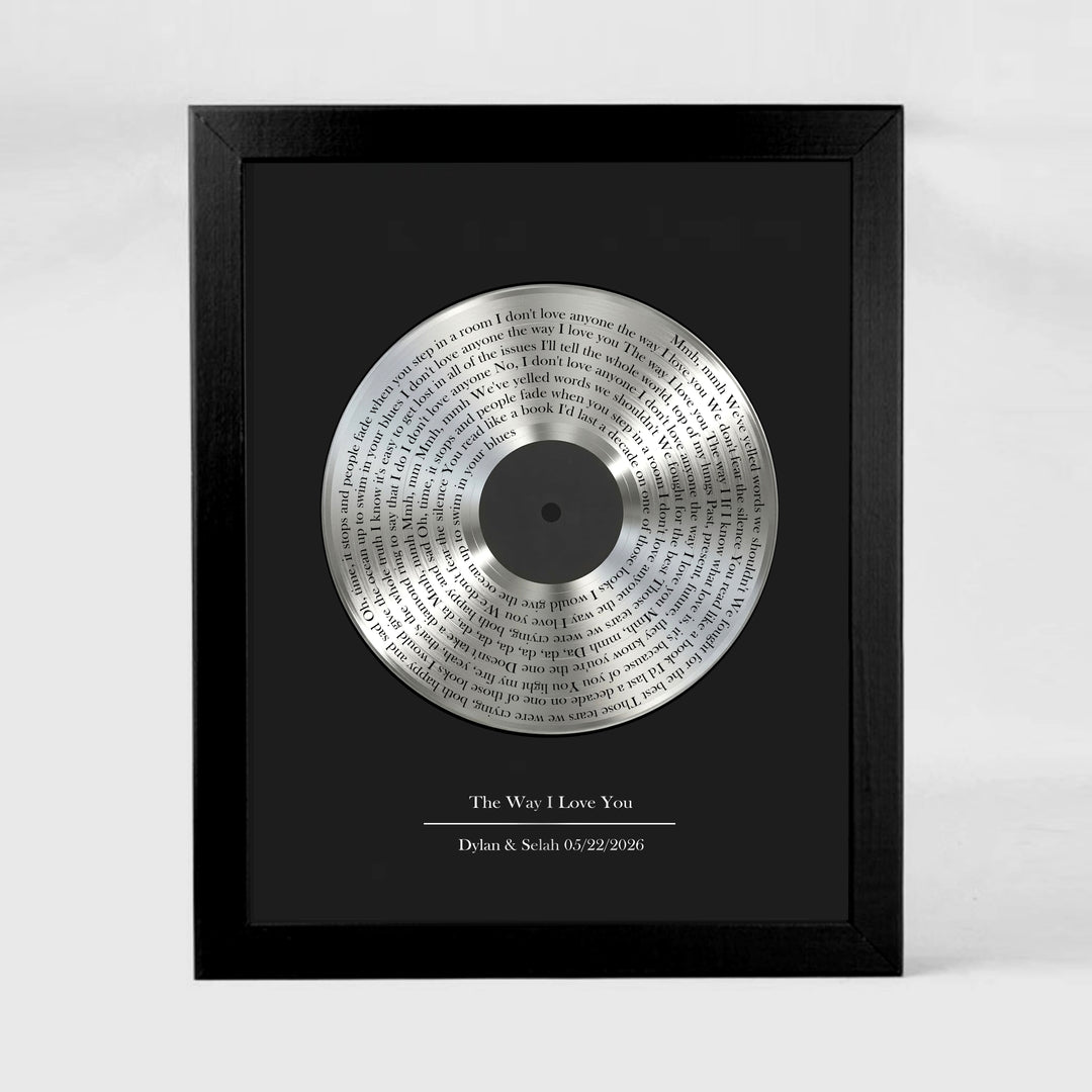 Framed tin vinyl record with engraved text on a black background
