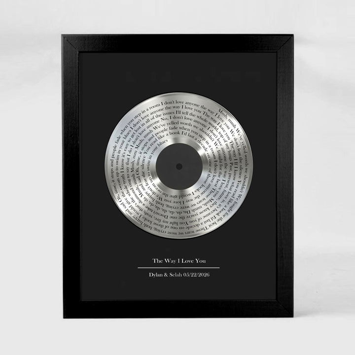 Framed tin vinyl record with engraved text on a black background