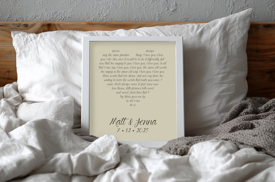Yellow anniversary gift custom lyrics print on a bed with white pillows and bedding